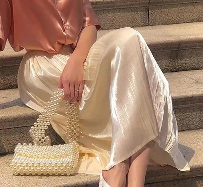 Upgrade Your Wardrobe with Our Spring and Autumn Half Length Pleated Skirt - Featuring Pearlescent Fabric and Elegant Pleats!